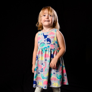 Kindy aged girl standing with black studio style background