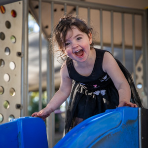 Kindy aged girl at the top of a slide