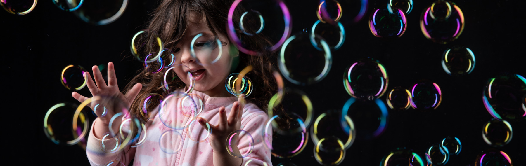 girl in studio surrounded by bubbles