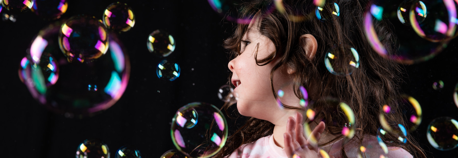 girl in studio surrounded by bubbles