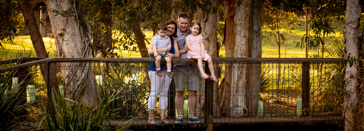 family on a bridge in the park